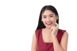 Portrait Asian beautiful girl in red dress and black long hair. Her hands touch cheek, smile, show beautiful skin on white background. photo