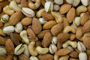 Mixed nut background. Cashews, almonds and pistachios. photo