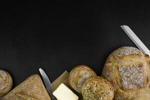 Freshly baked bread on a black background. Copy space. photo