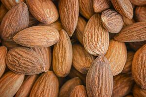 Almond background. Close-up of raw almonds, full frame. photo