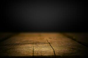 Empty old wooden table on black background photo