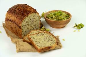 Organic bread of whole grain flour and hop sourdough. Dry hop flowers in wooden bowl and homemade bread. Craft bakery concept photo