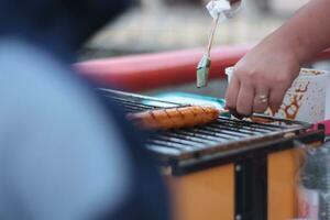 Indonesian street vendors prepare sausages outdoors photo