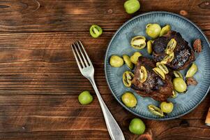 Grilled ostrich steak with kiwi berries photo