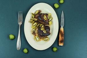 Grilled ostrich steak with kiwi berries photo