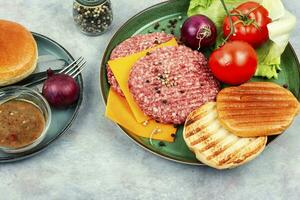 Raw ground burger patties for cooking. photo