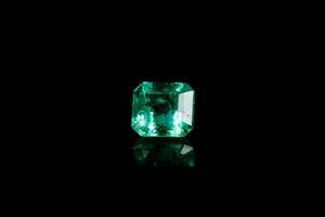 Macro mineral Emerald gemstone faceted on black background photo