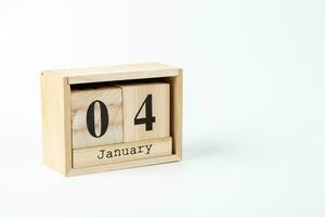 Wooden calendar January 04 on a white background photo