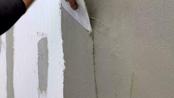 Hand with a putty knife, apply the putty to the wall. Process of applying a layer of putty. video