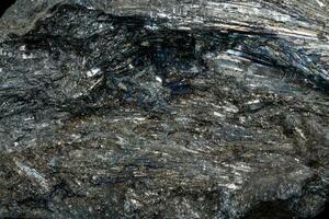 Macro of a stone Stibnite mineral on a black background photo