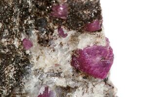 Macro of a mineral Ruby stone on a white background photo