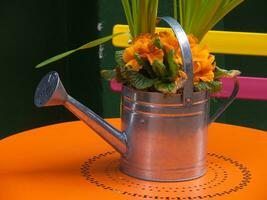 a watering can with flowers on it photo