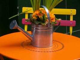 a watering can on a table photo