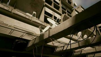 A skyscraper with a complex network of wires on its concrete roof video