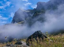 a mountain with clouds photo