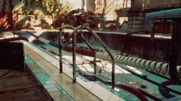 An abandoned swimming pool with a rusted metal railing video