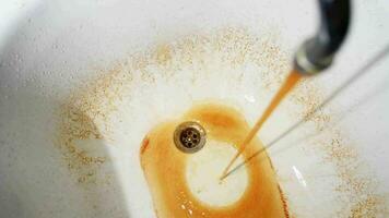 Rusty water flows from the faucet in the bathroom video