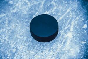 hockey puck lies on the snow macro photo