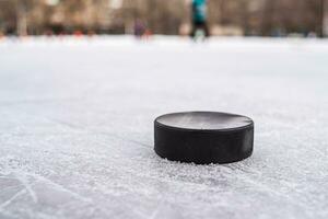 hockey puck lies on the snow macro photo