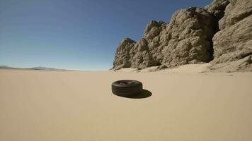 A tire sitting in the middle of a desert video