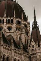 Budapest parliament building closeup tower on cloudy day photo