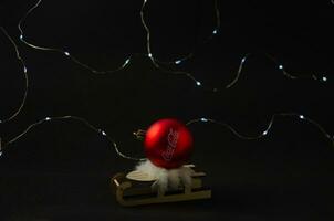 07.12.2023 St. Petersburg, New Year's ball with the inscription Coca Cola on a sled on a dark background photo