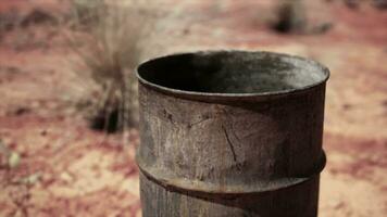 old empty rusted barrel on sand video