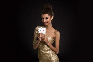 Pretty african girl shows two aces in casino poker and win photo