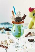 Milkshake with chocolate cookie, marshmallow and candy bar photo