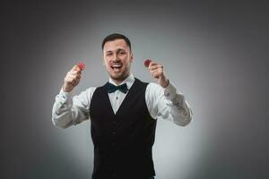 A man holding up red poker chips. Poker photo