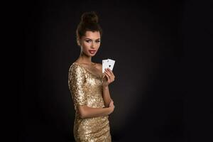 Pretty african girl shows two aces in casino poker and win photo