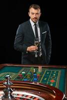 man in suit playing roulette. addiction to gambling. photo