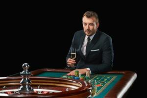 man in suit playing roulette. addiction to gambling. photo