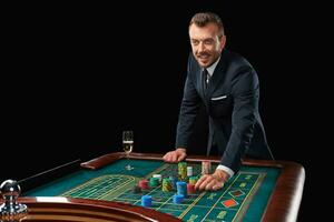 man in suit playing roulette. addiction to gambling. photo