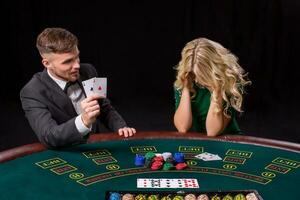 couple playing poker at the table. photo