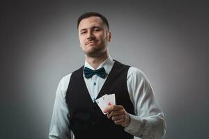 Handsome confident man holding cards looking at camera. photo