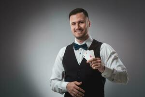 Handsome confident man holding cards looking at camera. photo