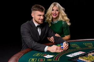 View of young, confident, man with the lady while he's playing poker game. photo