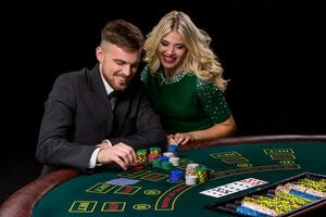 View of young, confident, man with the lady while he's playing poker game. photo