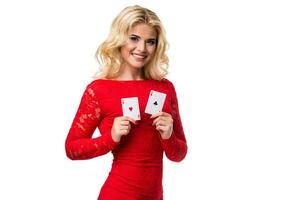 Caucasian young woman with long light blonde hair in evening outfit holding playing cards. Isolated. Poker photo
