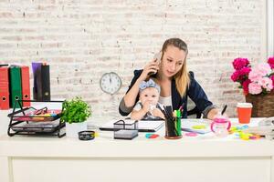 Family Business - telecommute Businesswoman and mother with kid is making a phone call photo