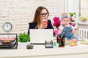 Businesswoman mother woman with a daughter working at the computer photo