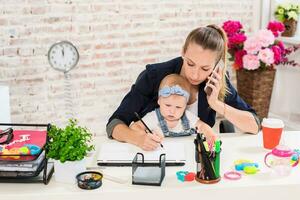 Family Business - telecommute Businesswoman and mother with kid is making a phone call photo