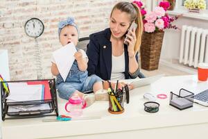 Family Business - telecommute Businesswoman and mother with kid is making a phone call photo