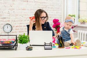 Businesswoman mother woman with a daughter working at the computer photo