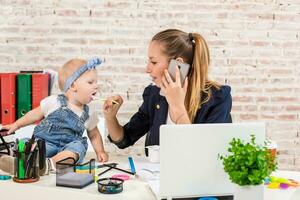 Family Business - telecommute Businesswoman and mother with kid is making a phone call photo