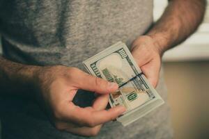 A man holds dollars in his hands photo