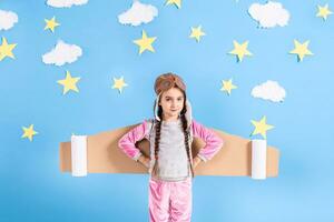 Little child girl in an astronaut costume is playing and dreaming of becoming a spaceman. photo