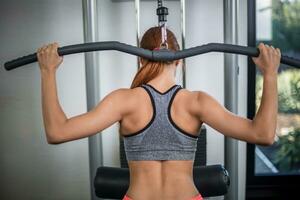 Photo of woman doing exercises on the simulator