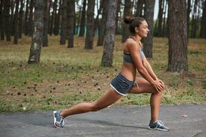 Young woman running outdoors in a city park photo